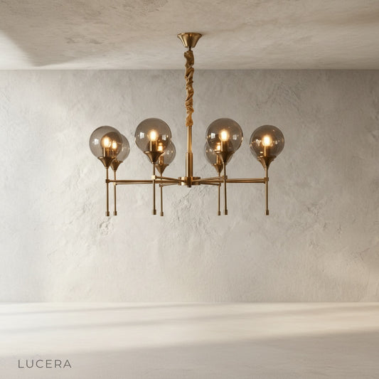 studio shot of Erbaluce chandelier with five glass globes on iron arms
