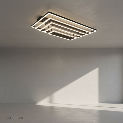 front view of rectangular LED ceiling light with brushed metal frame and soft diffused lighting in studio setting