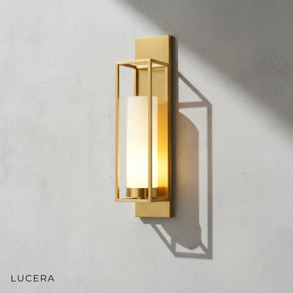 Close-up of ornate copper detailing and luminous glass shade on wall sconce