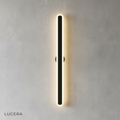 Close-up of Diminuendo wall lamp showing brushed metal mount and acrylic edge