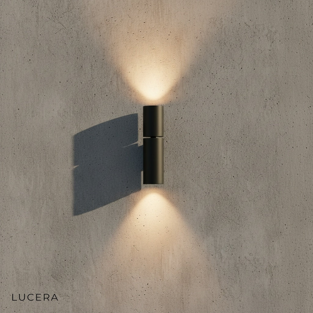 Canopus wall light casting dramatic up and down light patterns on stucco wall at night