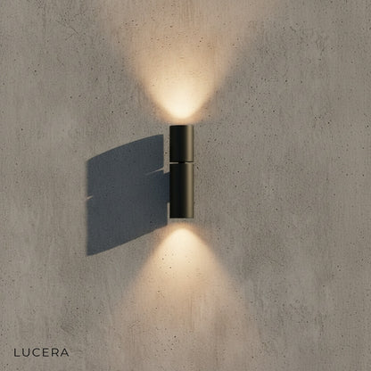 Canopus wall light casting dramatic up and down light patterns on stucco wall at night