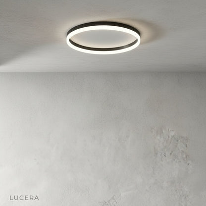 studio shot of round metal ceiling light with acrylic diffuser