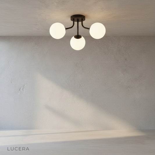 minimalist Crypt ceiling light mounted on white ceiling, three-tier glass sphere design