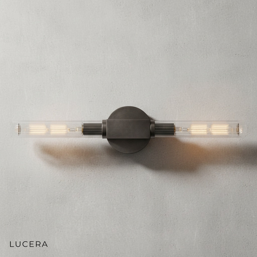Close-up of Ravello wall lamp brass finish showing iron frame and clear glass