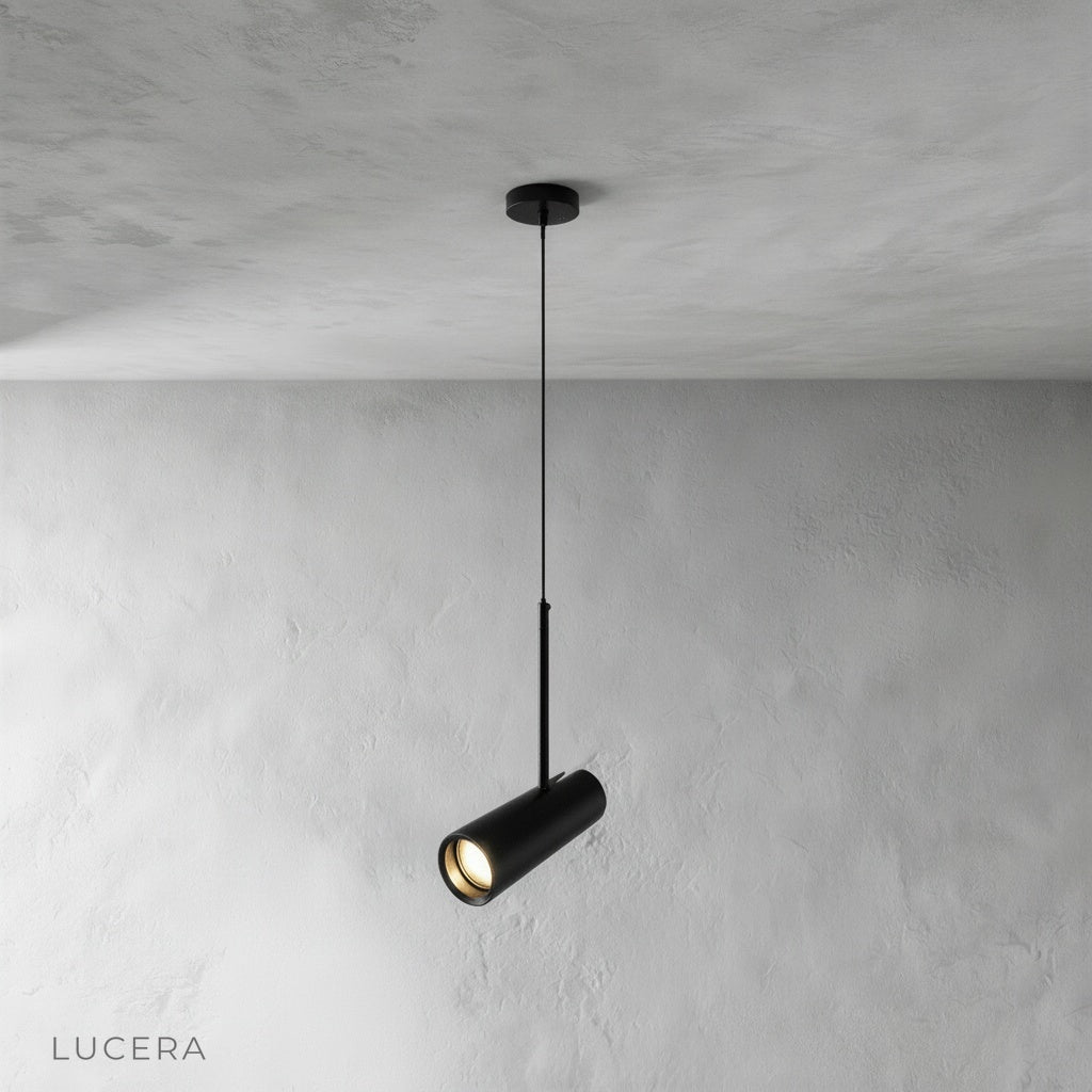 Studio shot of black Bistre pendant light with single cylindrical aluminum shade on clean background
