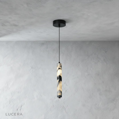 studio shot of a slender cylindrical marble pendant light on a clean white background