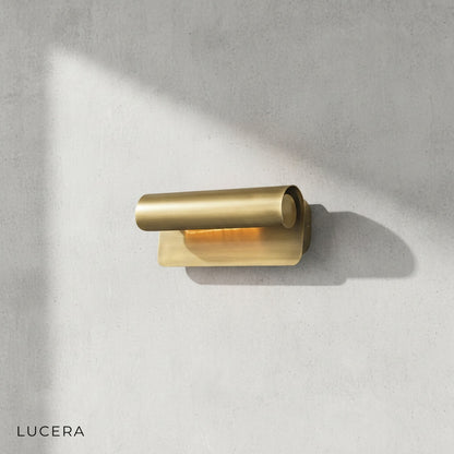 close-up of Tresse scroll sconce brass texture and warm 3000K light