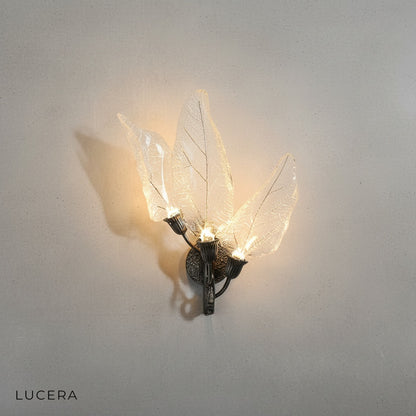 close up of metal frame and soft acrylic diffuser on black leaf wall lamp