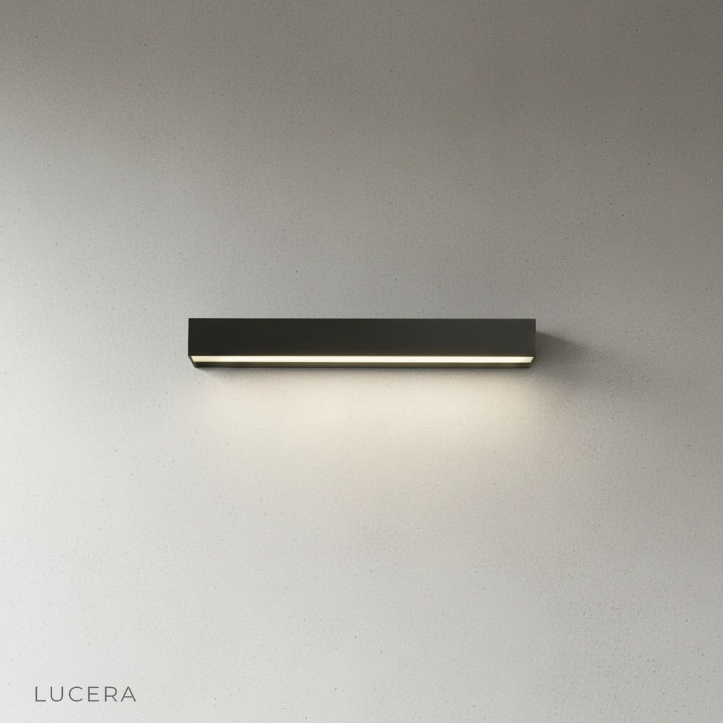 Goccia wall lamp studio shot on light gray background, side angle highlighting slim profile