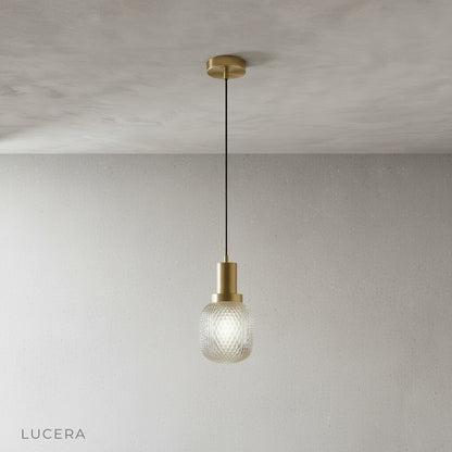 Studio view of Lucera Silvia pendant light showing brass base and glass details