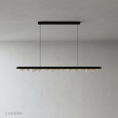 Minimalist studio view of the linear skyline-inspired pendant light from Lucera in a clean white setting