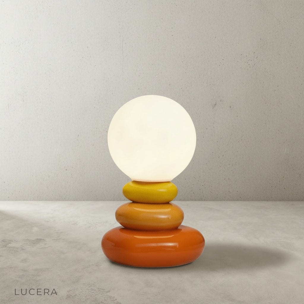 Minimalist product view of sculptural yellow ochre ceramic lamp base against clean white background