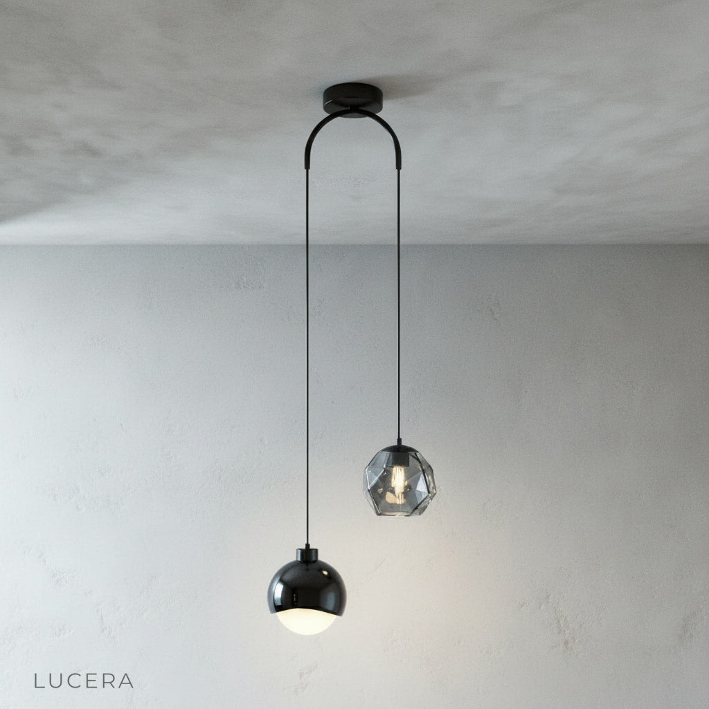 Black Vale pendant light hanging from a ceiling, clean studio background, front view