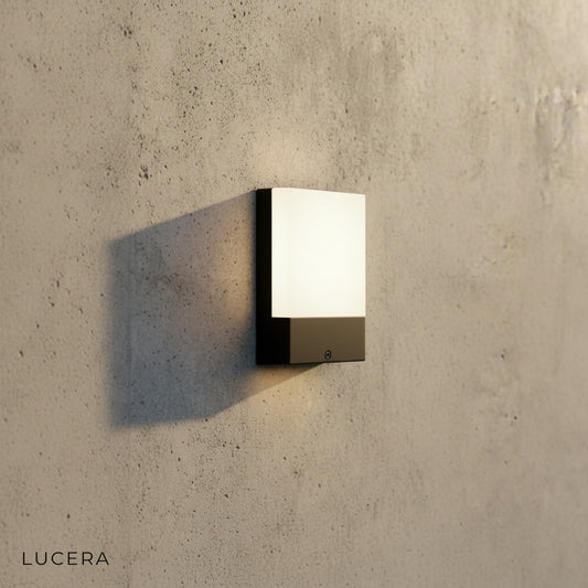 minimalist aluminum LED wall sconce on neutral gray studio background