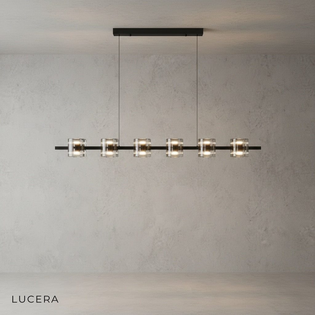 Harlequin chandelier illuminated with warm light against dark wall in entryway
