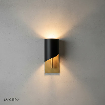 Duomo wall sconce with warm 3000K LED light illuminating a cozy living room corner