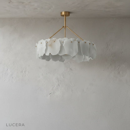 Studio view of copper chandelier with sculptural alabaster shades from side angle