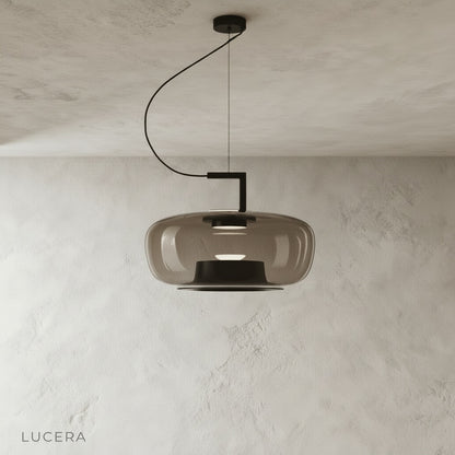Yardang pendant light front view studio shot with clear glass shade and black metal frame
