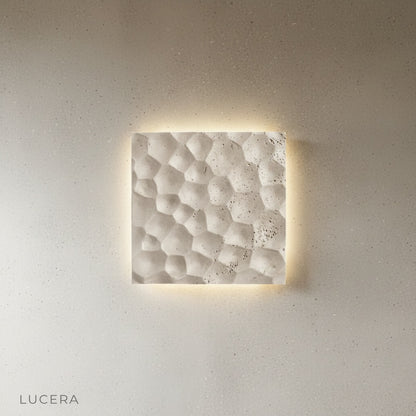 Hexagonal black stone wall sconce side angle studio product shot