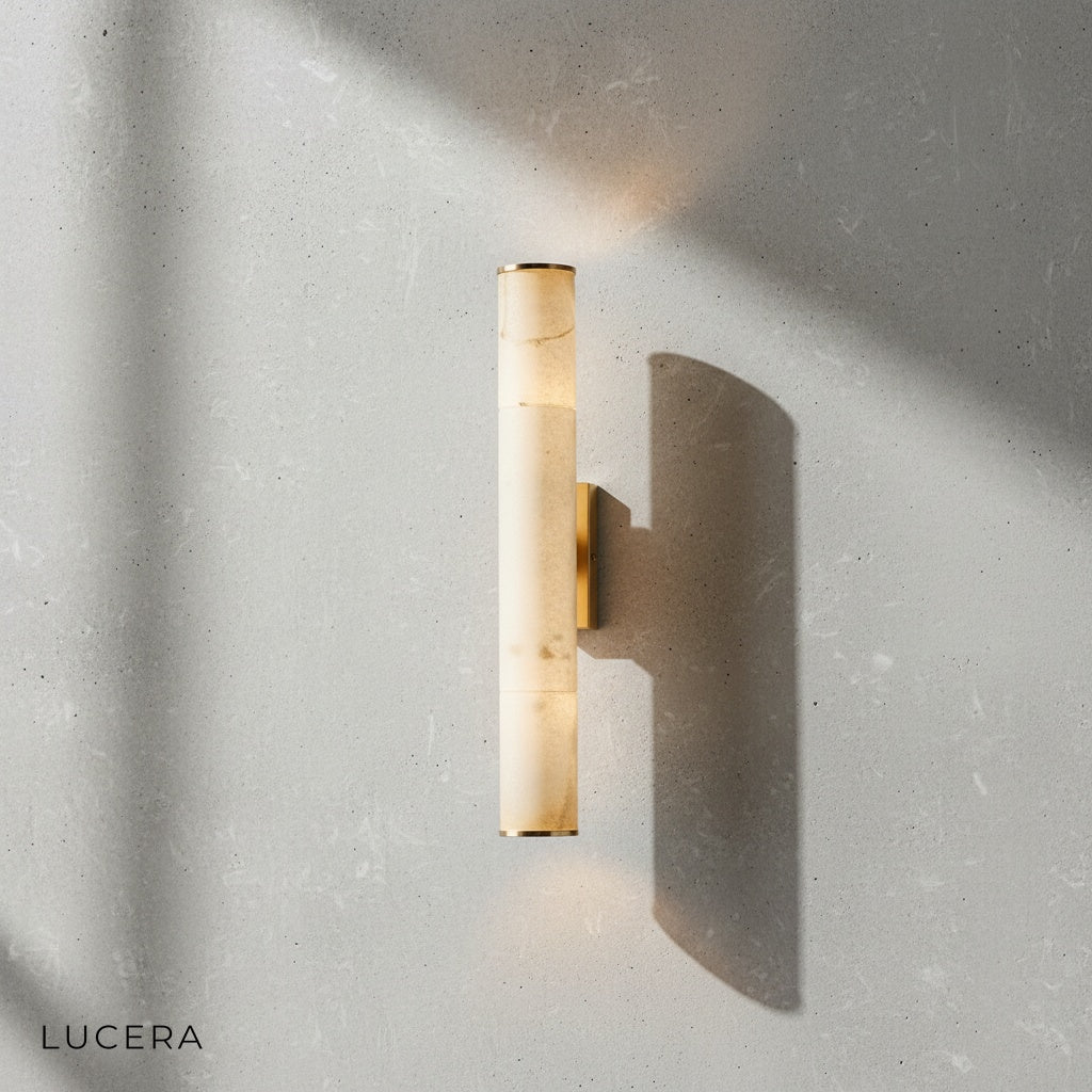 Close-up detail of marble veining and brushed iron finish on Ethos wall sconce