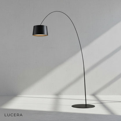Gabbro arc lamp in neutral 4000K light next to a reading chair and side table