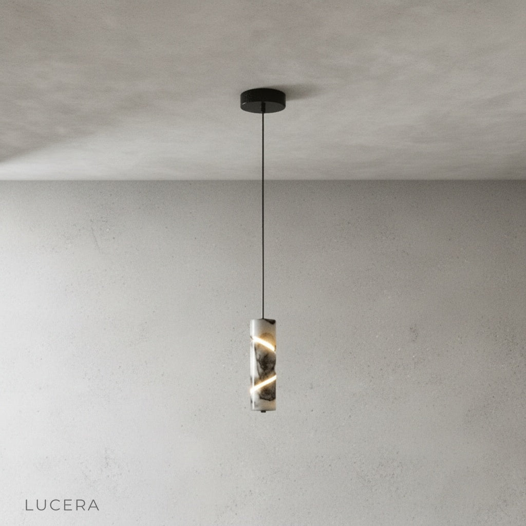 Minimalist cylinder marble pendant light on clean grey background, front view
