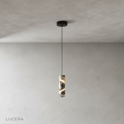 Minimalist cylinder marble pendant light on clean grey background, front view