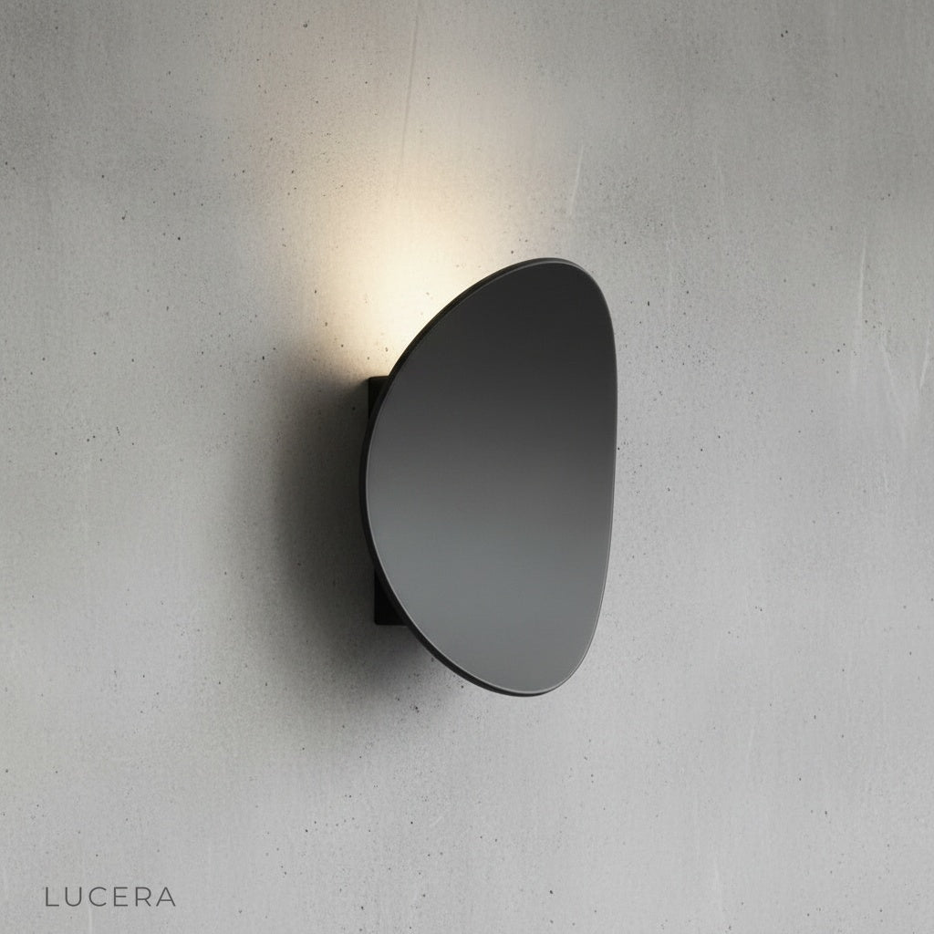 curved black wall lamp studio view against neutral gray backdrop