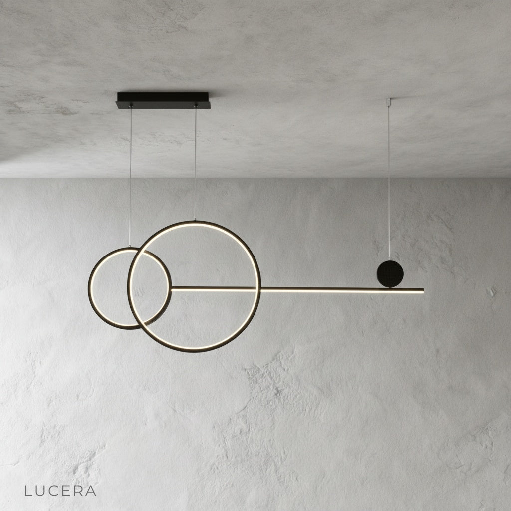 Black Brumal pendant light hanging from ceiling in minimalist studio setting