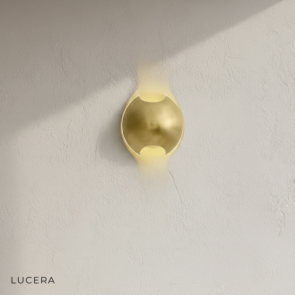 Close-up of brass and wenge semi sphere wall lamp showing textured wood grain