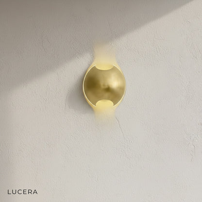 Close-up of brass and wenge semi sphere wall lamp showing textured wood grain