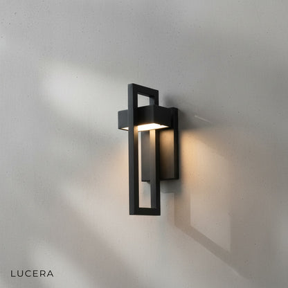 Knox wall light casting cool light on modern concrete facade