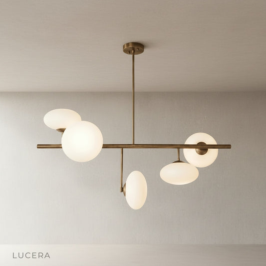 Studio shot of Naples Yellow Chandelier front view with five opal glass globes