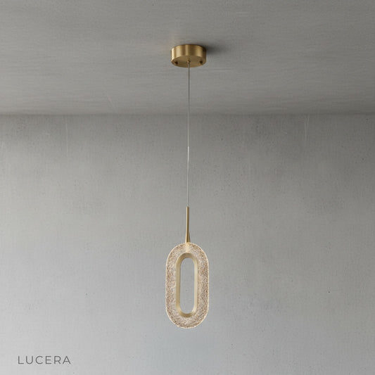 Studio shot of Warmth Pendant Light oval copper and aluminum fixture with textured acrylic shade