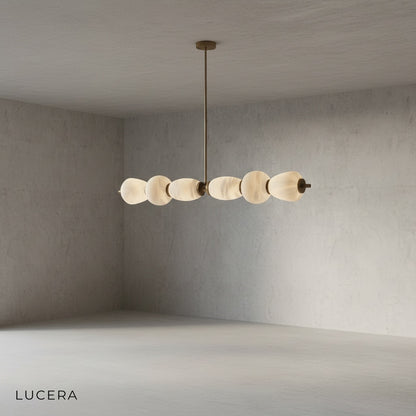 close-up of natural marble veining and brushed copper hardware on linear chandelier