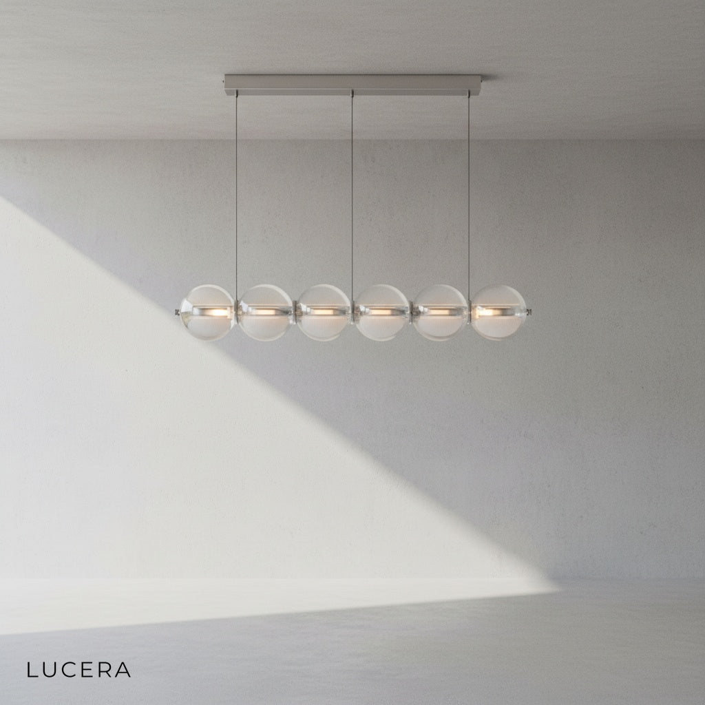 Vermeil pendant light with warm glow over kitchen island in contemporary home