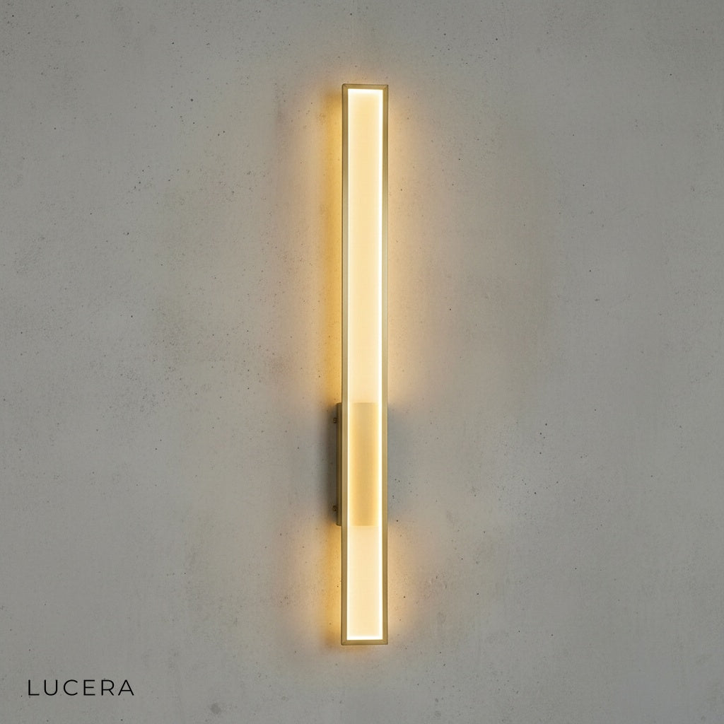 black finish Sotto Retro sconce glowing softly above a bedside table in a bedroom