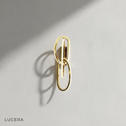 close-up detail of acrylic shade and brushed steel arm on luxury wall lamp