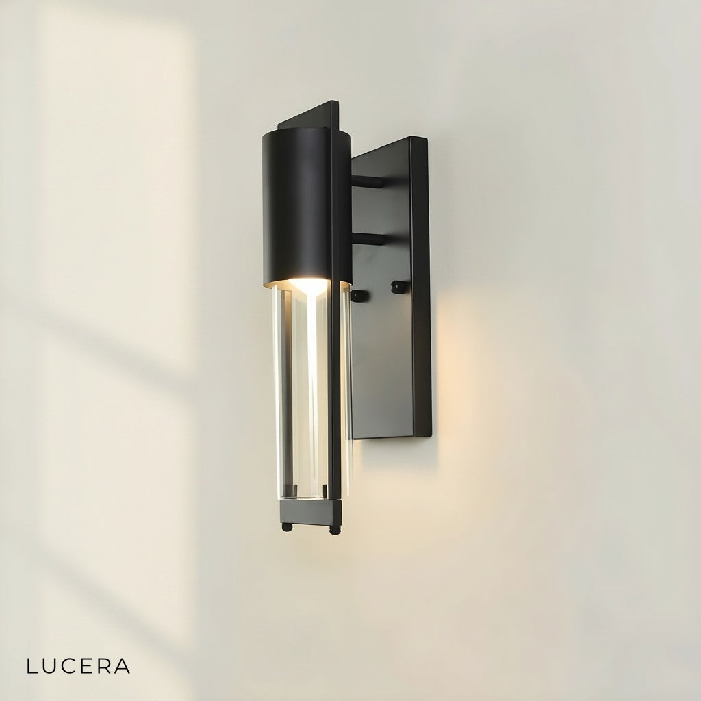 Detail of the clear glass diffuser showing the warm LED glow of the Viviane sconce