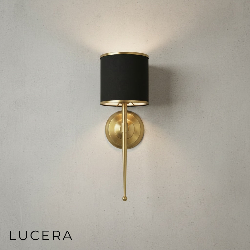 Close-up of Morendo wall sconce metal frame joint and warm bulb glow detail