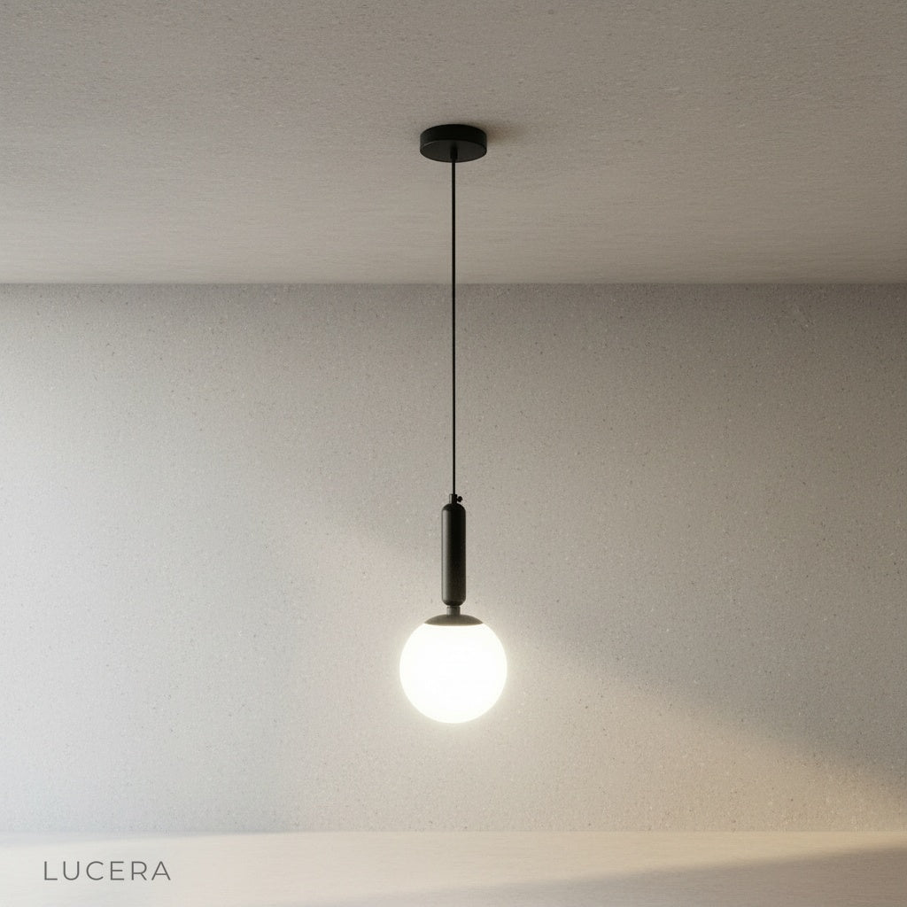 Yvaine pendant light hanging from ceiling cable in minimalist studio setting
