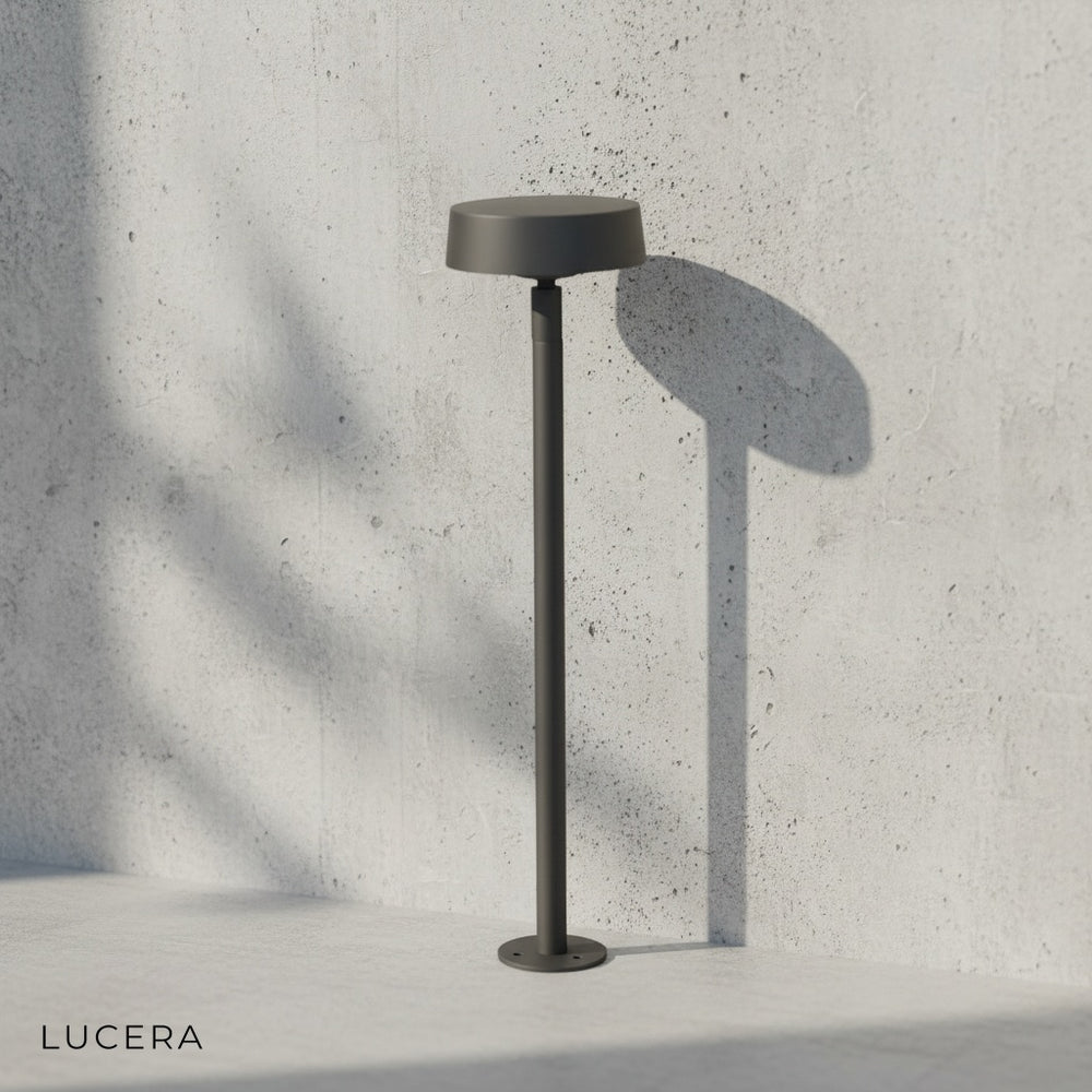 minimalist black bollard light on clean white background, front view