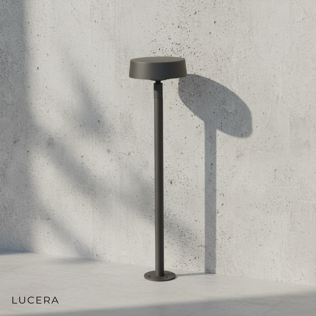 minimalist black bollard light on clean white background, front view