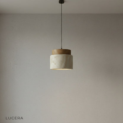 Tenebra ceiling light front angle studio shot with natural travertine stone and oak finish