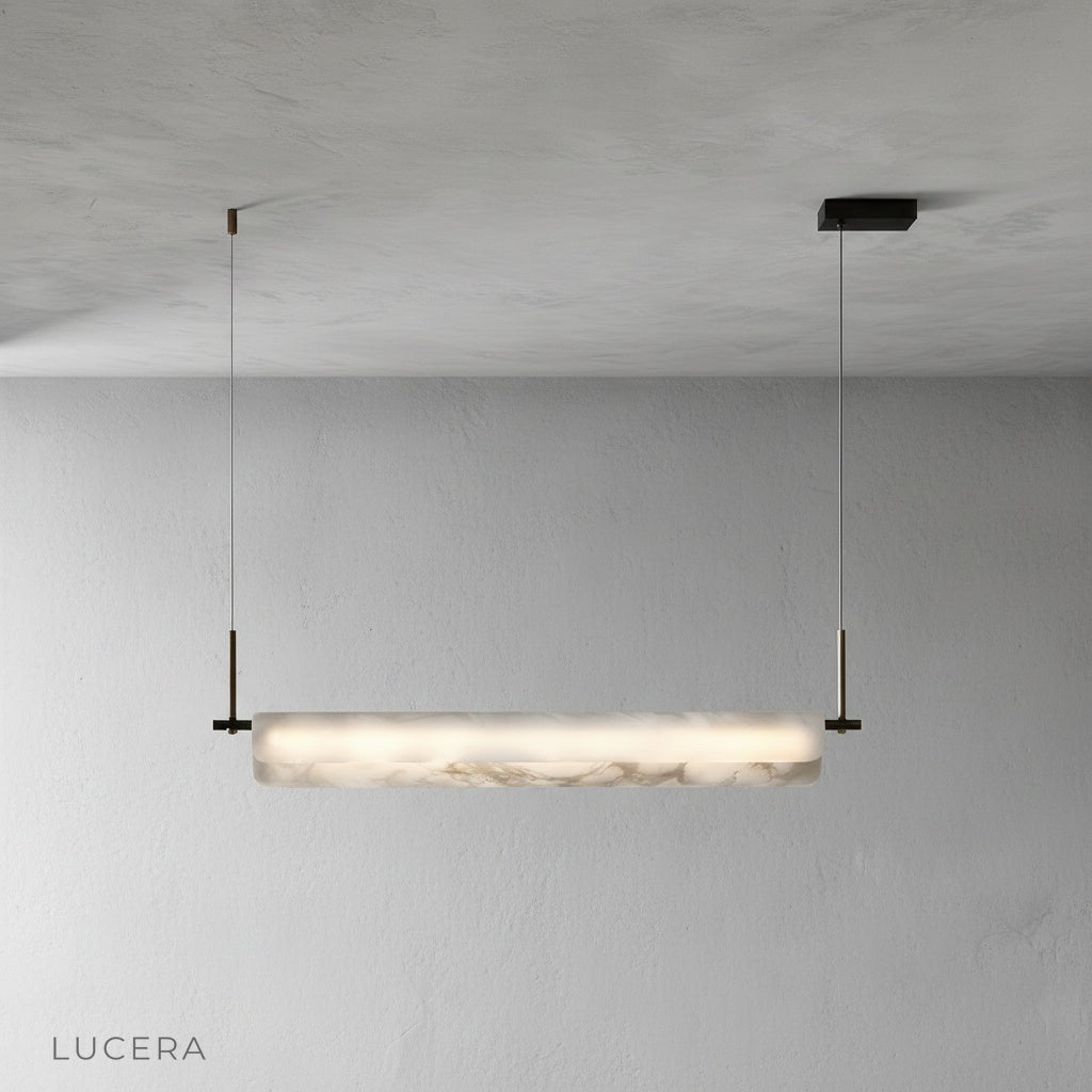Minimalist studio view of the Lucera pendant light with its linear black canopy and alabaster shade