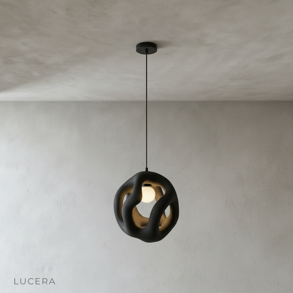 front view of Lucera flame pendant light hanging from ceiling in minimalist studio setting