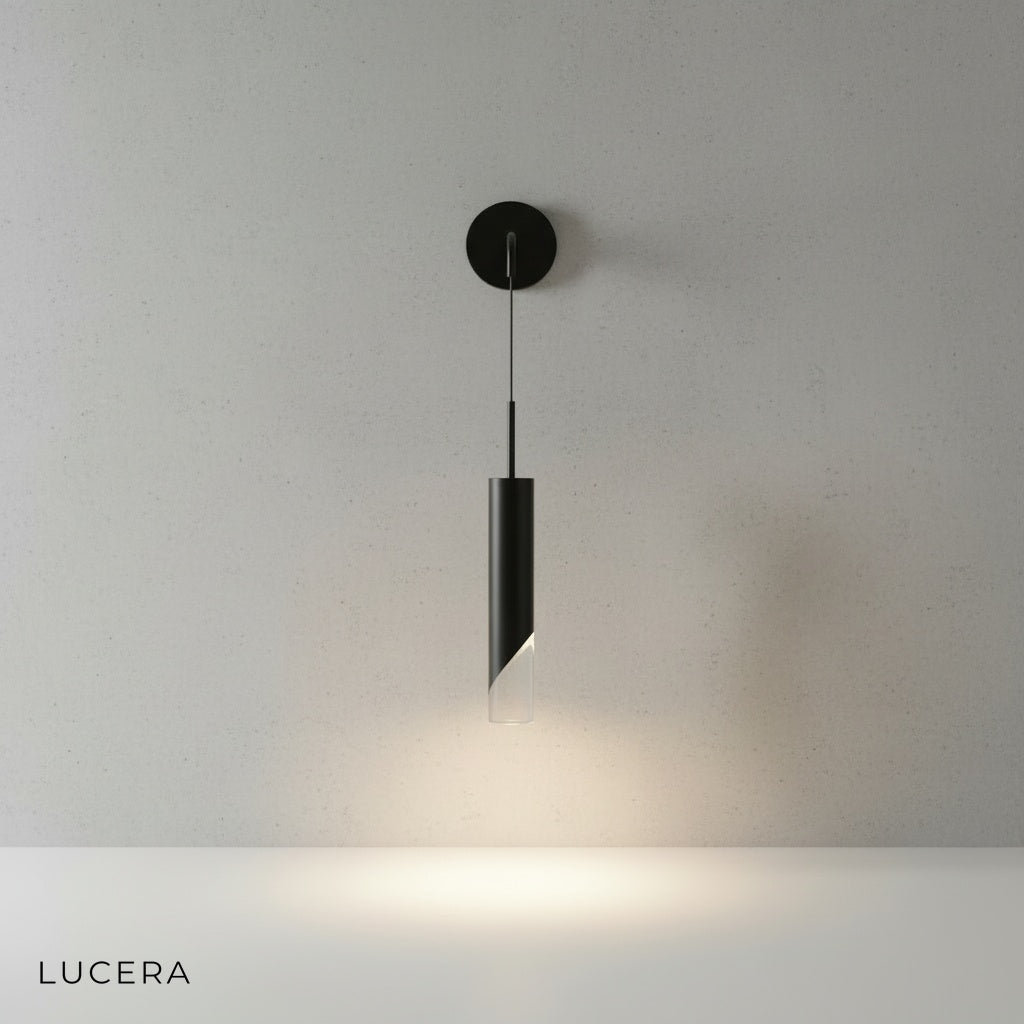 vertical sconce with warm light wash illuminating textured plaster wall in hallway