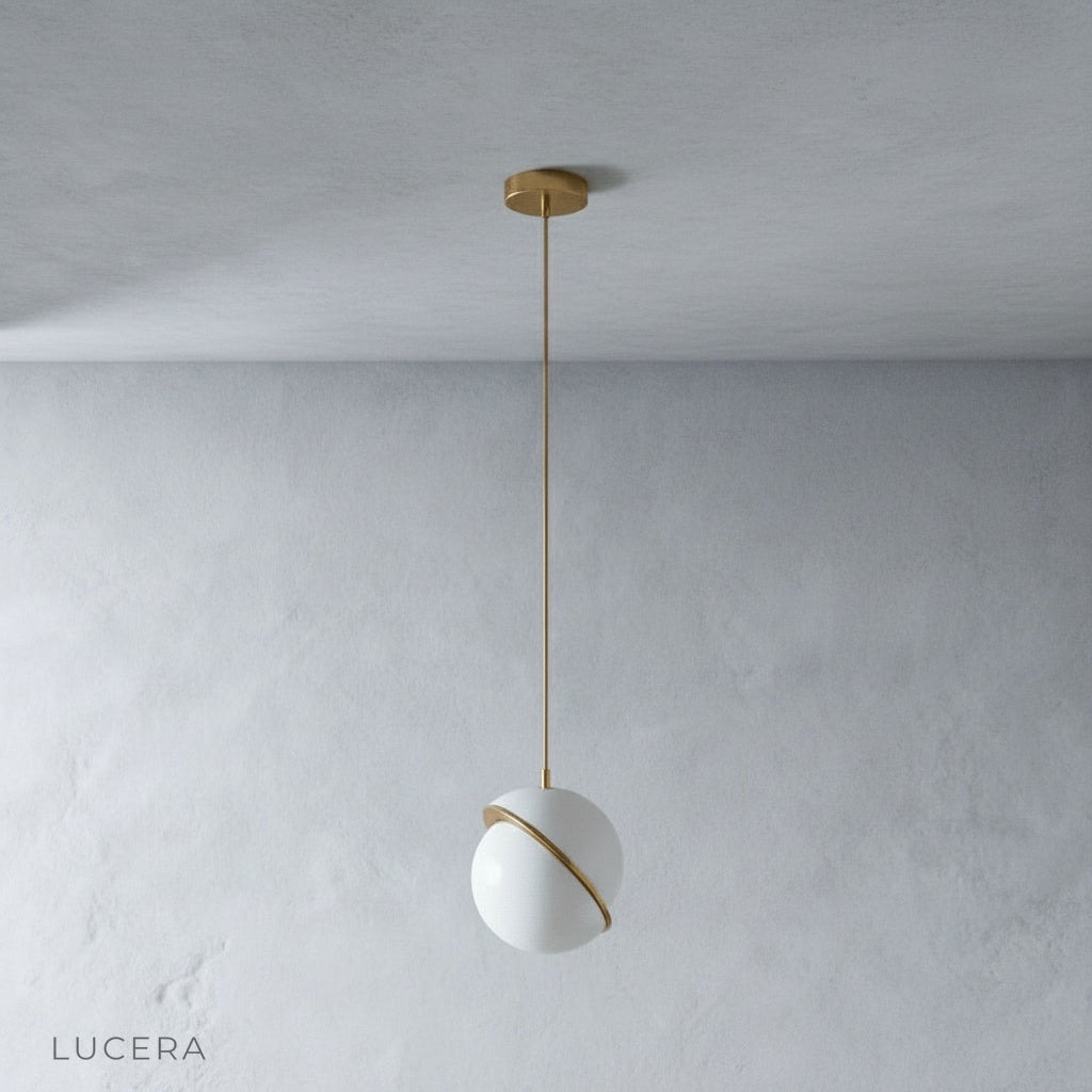 Igneous pendant light side angle studio view showing asymmetric sliced sphere design