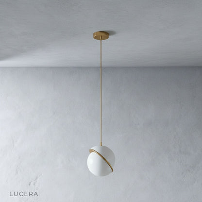 Igneous pendant light side angle studio view showing asymmetric sliced sphere design